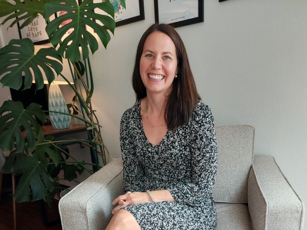 Photo of Kayli Julius, CHC Wellbeing Director, smiling in the Wellbeing Office.