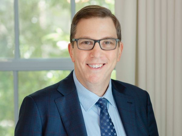 Photo of Stephen Vladek in a suit