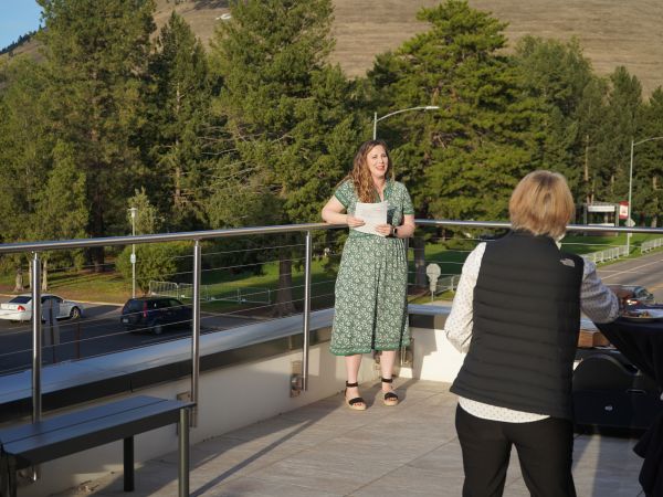 Morgan Slemberger speaking on a balcony
