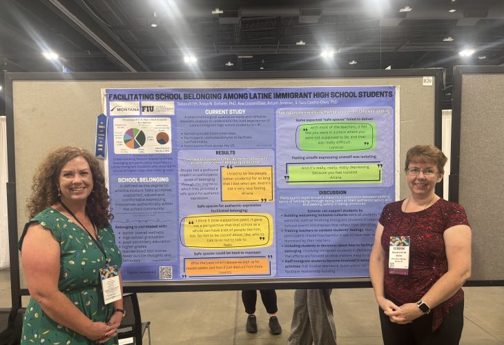 Dr. Goforth and a graduate student standing in front of a poster at a conference