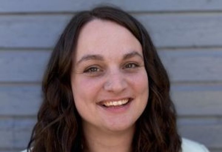 headshot of Kassidi Heinle, a woman with dark brown hair dropping past her shoulders