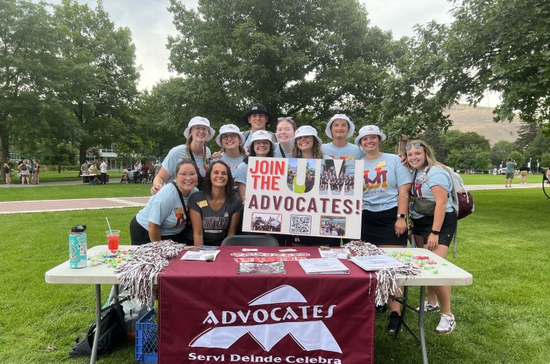 UM Advocates pose holding a "Join UM Advocates" sign 2023