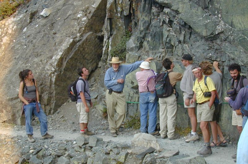 Don and a group in front of a rock face