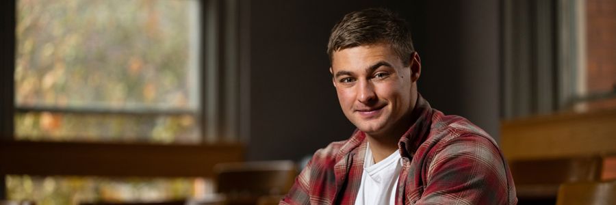 headshot of a student sitting in a classroom looking into the camera