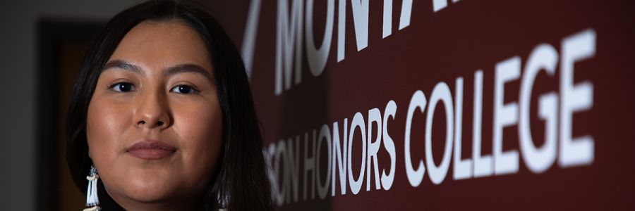 headshot of a student next to a sign for the Davidson Honors College