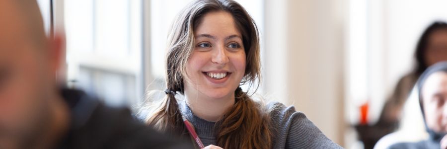 smiling student in a classroom
