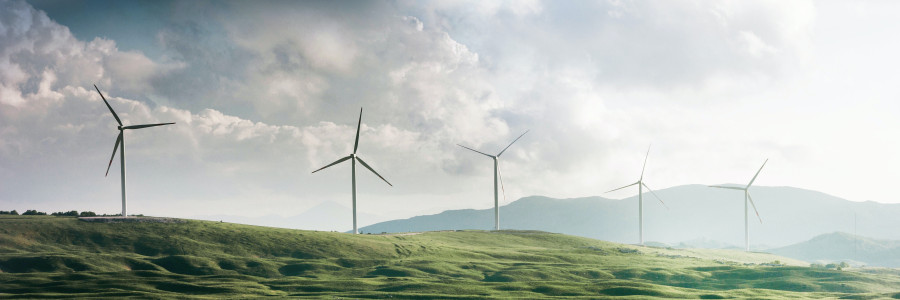rolling green hills with wind turbines